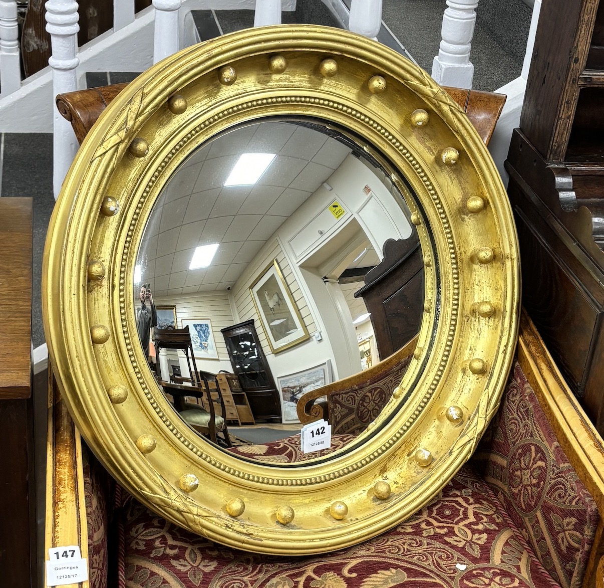 A Victorian giltwood and composition convex wall mirror, diameter 65cm